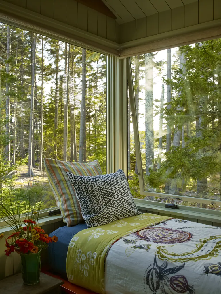 Large windows offering expansive views of the trees at Capitol Island