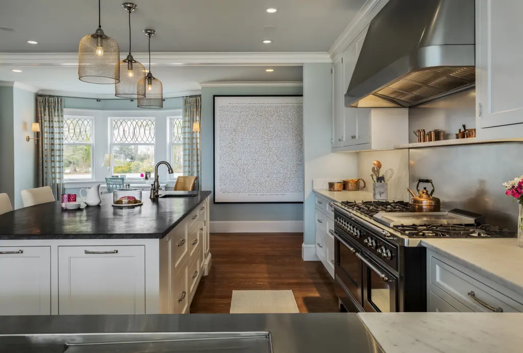 Large open kitchen with expansive island and industrial stove at Foreside Kitchen