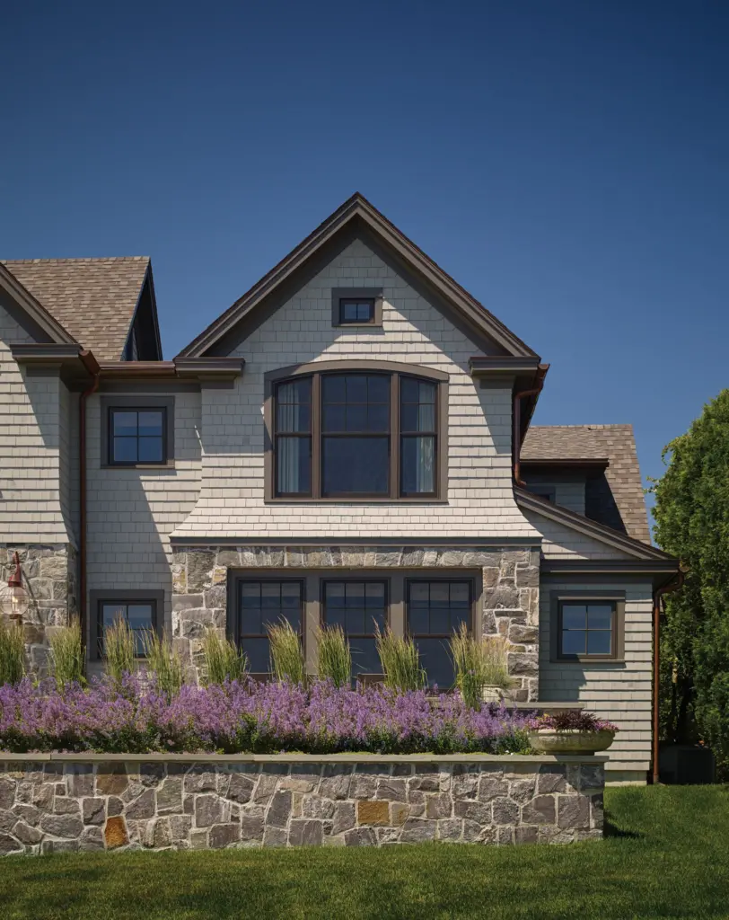 An exterior view of the cottage with a flower garden and stone details