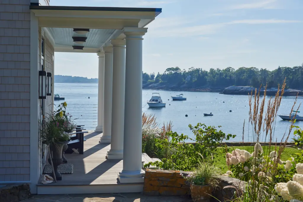 Refreshing side profile of Twin Cove's front porch with coastal views and unique fixtures.