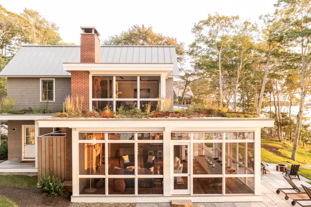 A side profile of the coastal home highlighting the green roof